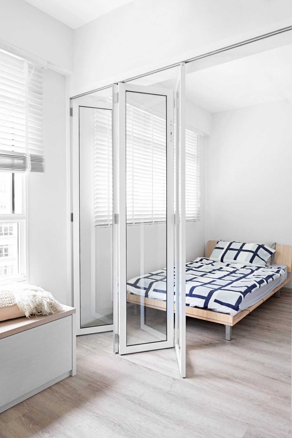 Scandinavian Bedroom with Paintings and Bed
