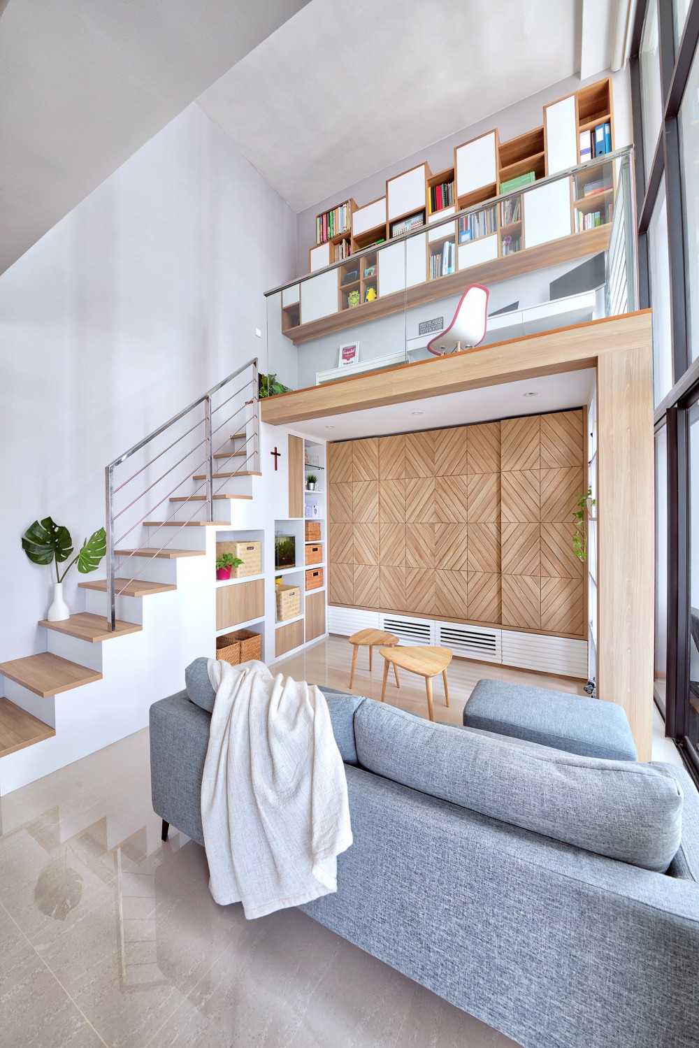 Scandinavian Living Room with Bookshelf and Staircase