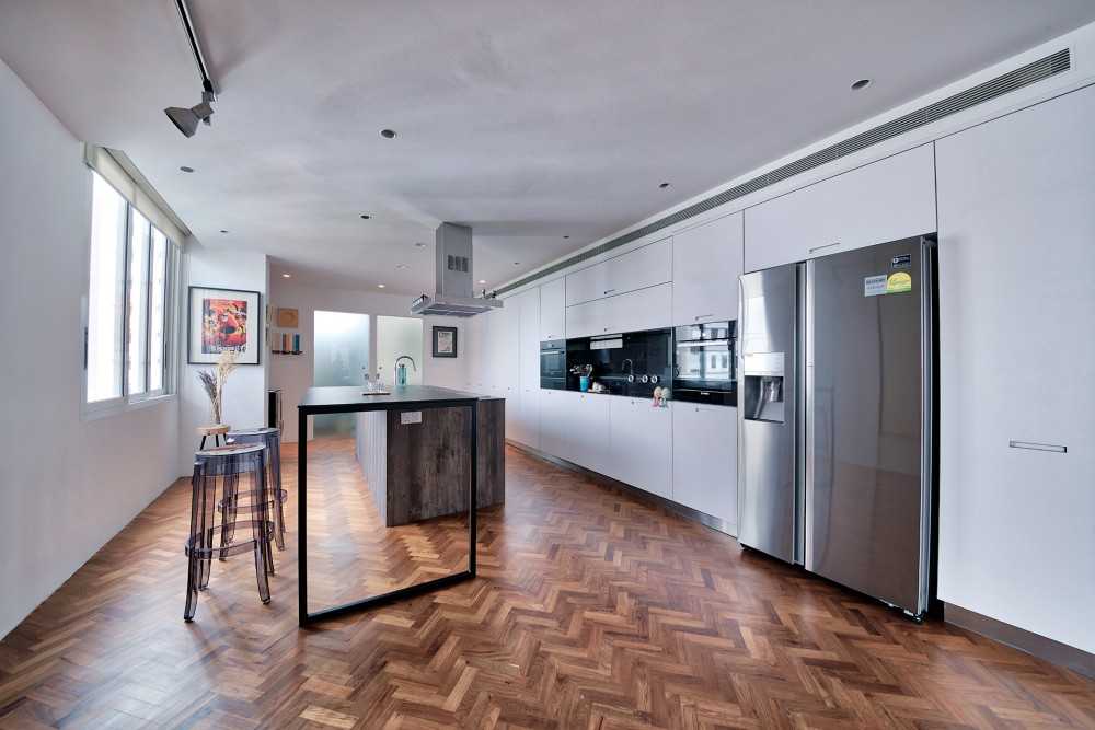 Contemporary Kitchen with Wood Flooring and Bar Counter