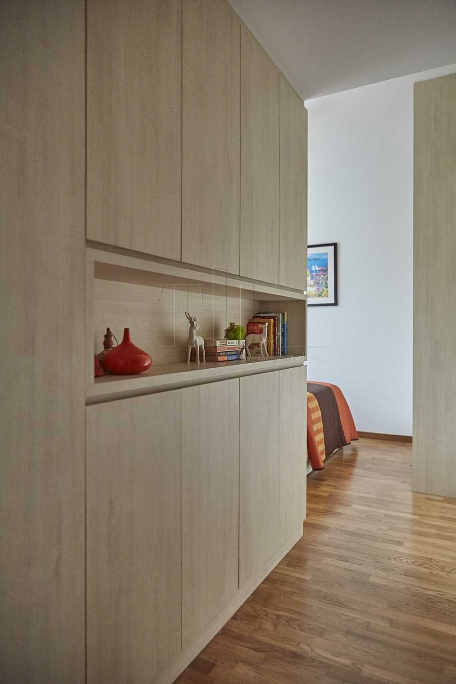 Minimalist Hallway with Bookshelf and Wood Flooring