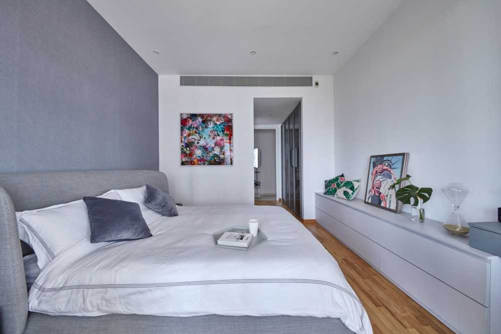 Modern Bedroom with Wood Flooring and Paintings