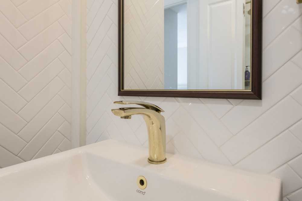Scandinavian Bathroom with Herringbone Tiling and Mirror