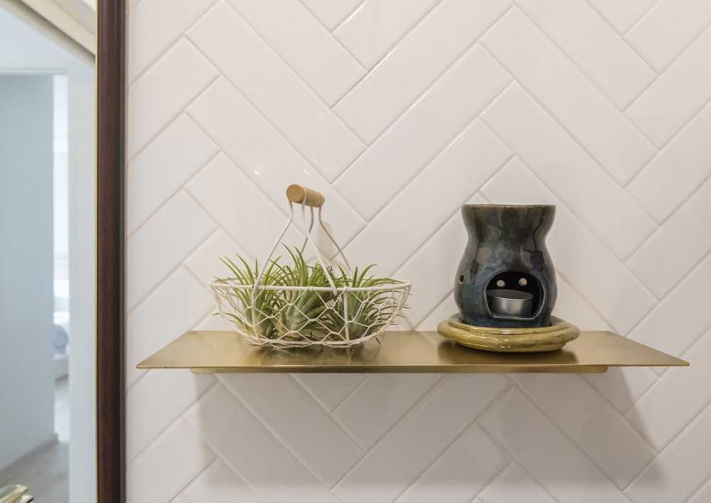 Scandinavian Bathroom with Herringbone Tiling and Wall Shelves
