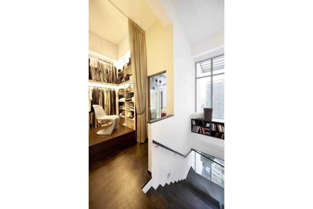 Eclectic Walk-in Wardrobe with Staircase and Clothes Storage
