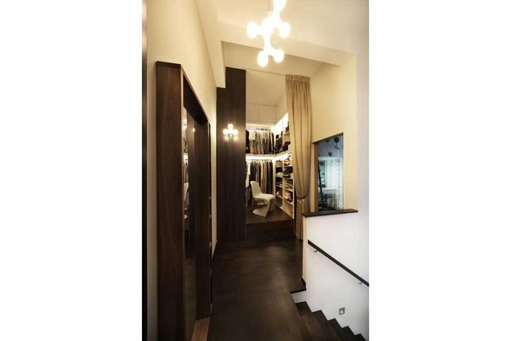 Eclectic Walk-in Wardrobe with Chandelier and Clothes Storage
