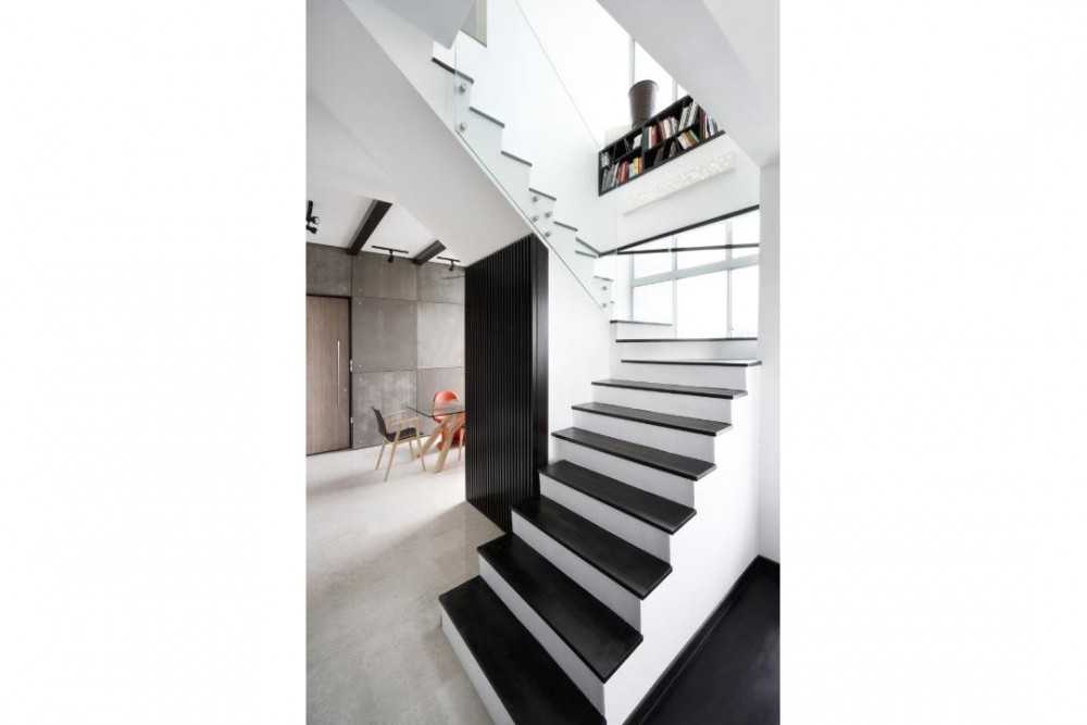 Eclectic Hallway with Bookshelf and Staircase