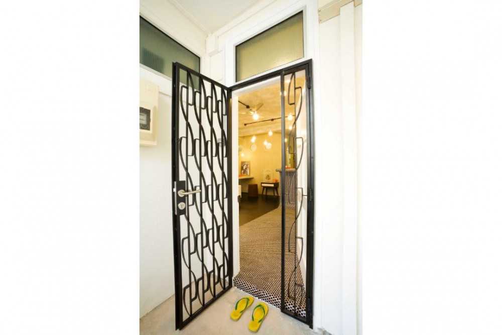 Eclectic Entryway with Drop Light and Metal Gate