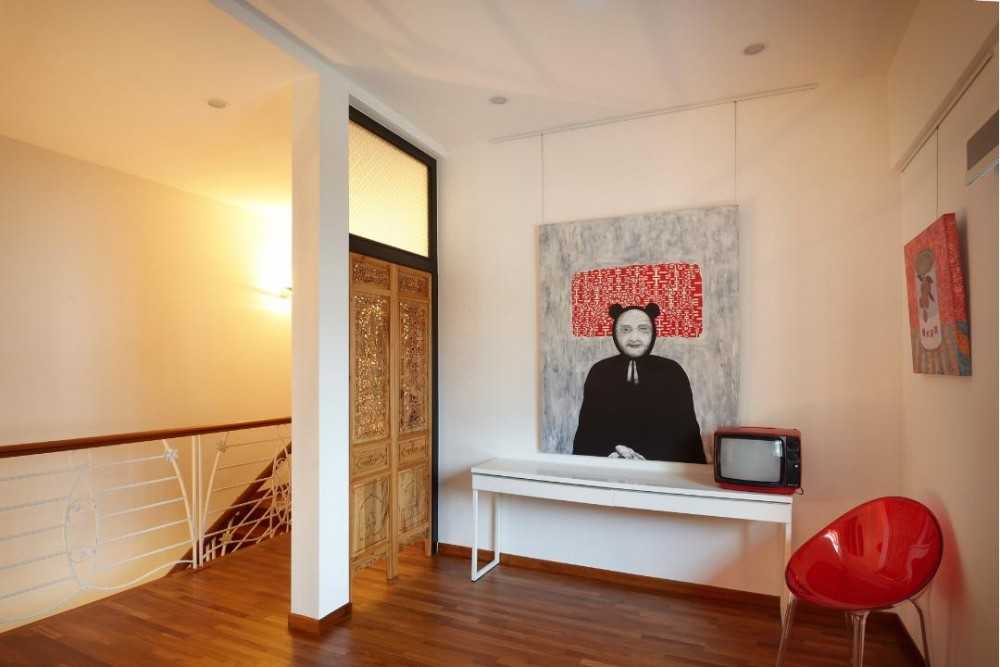 Eclectic Hallway with Wood Flooring and Artwork