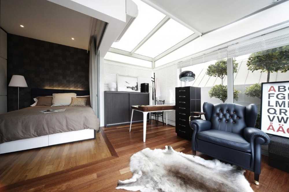 Eclectic Bedroom with Wood Flooring and Armchairs