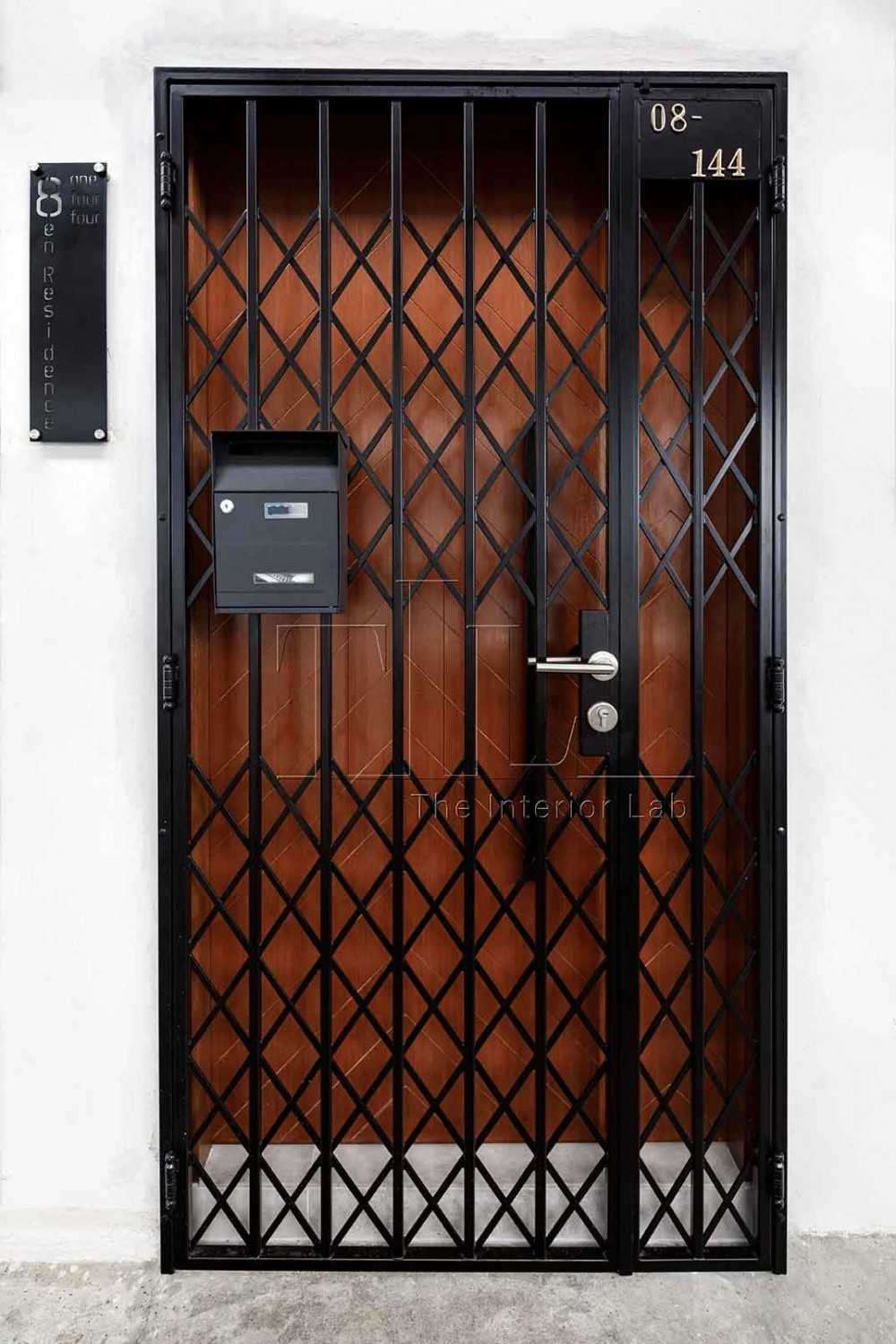 Industrial Entryway with Herringbone Tiling and Metal Gate