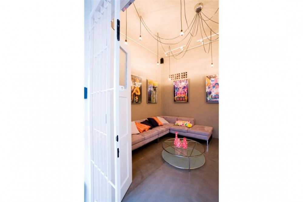 Eclectic Shopfront with Cement Floor and Drop Light