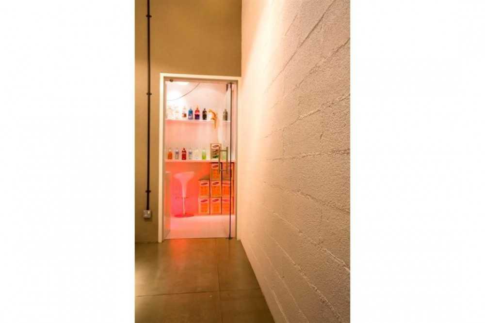 Eclectic Hallway with Cement Floor and Feature Wall