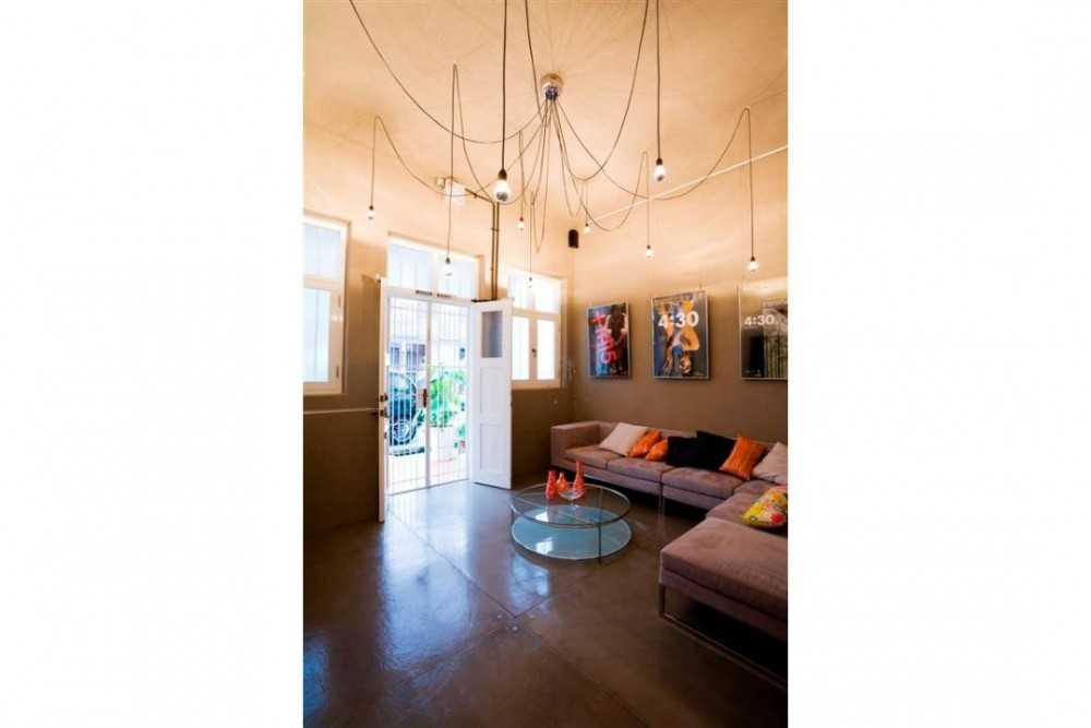 Eclectic Living Room with Drop Light and Sofa