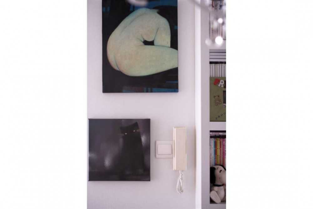 Eclectic Entryway with Bookshelf and Paintings