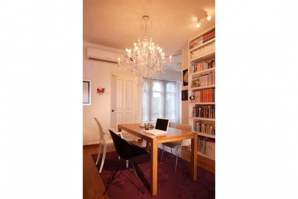 Eclectic Dining Room with Bookshelf and Chandelier