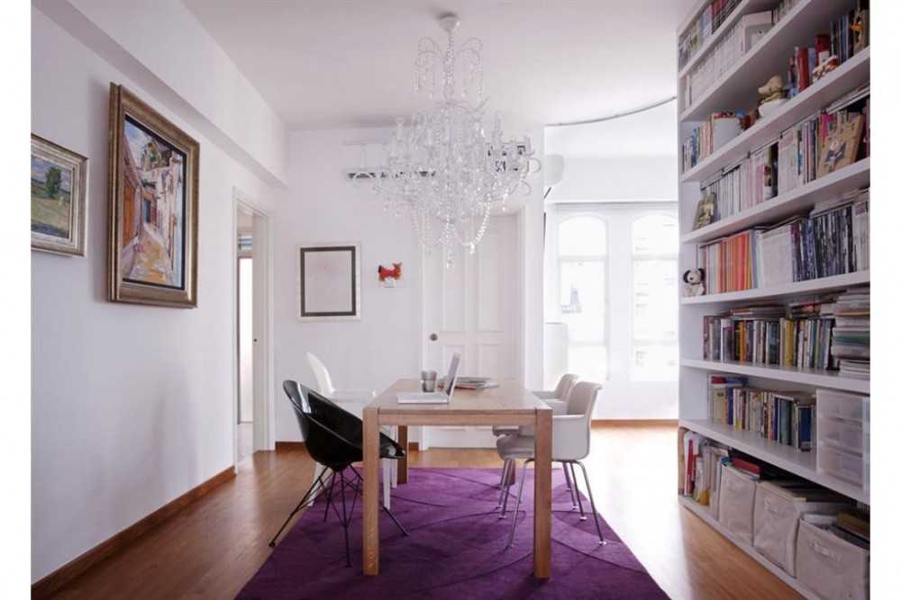 Eclectic Dining Room with Bookshelf and Chandelier