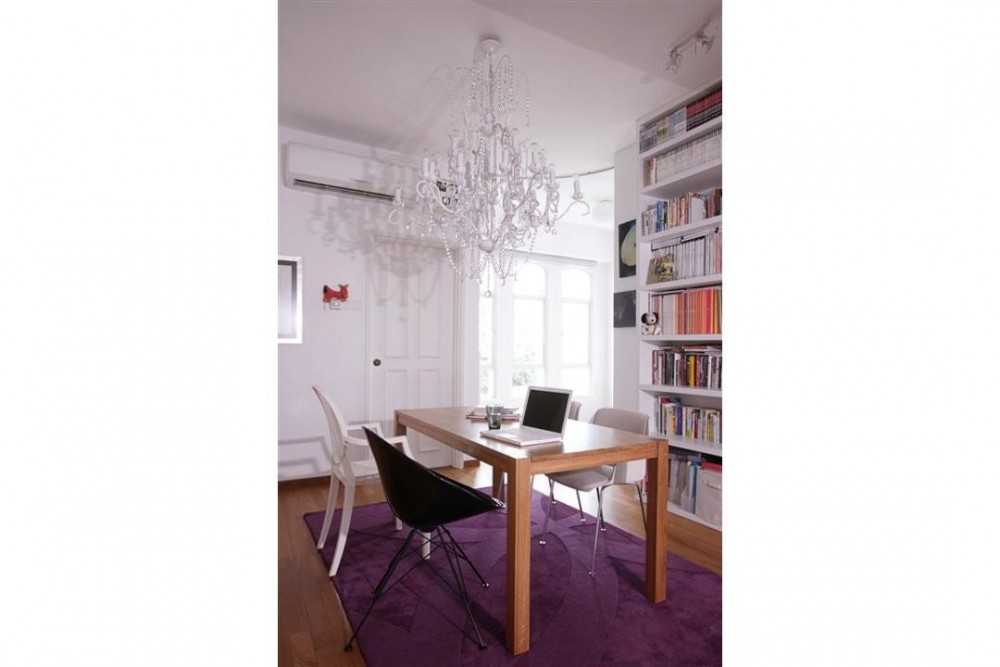 Eclectic Dining Room with Bookshelf and Chandelier