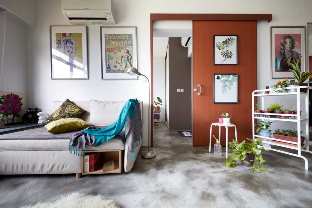Eclectic Living Room with Cement Floor and Paintings