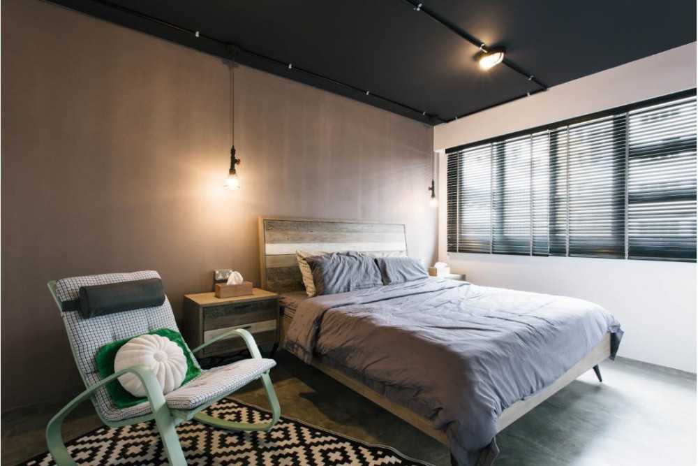 Industrial Bedroom with Drop Light and Bedside Table