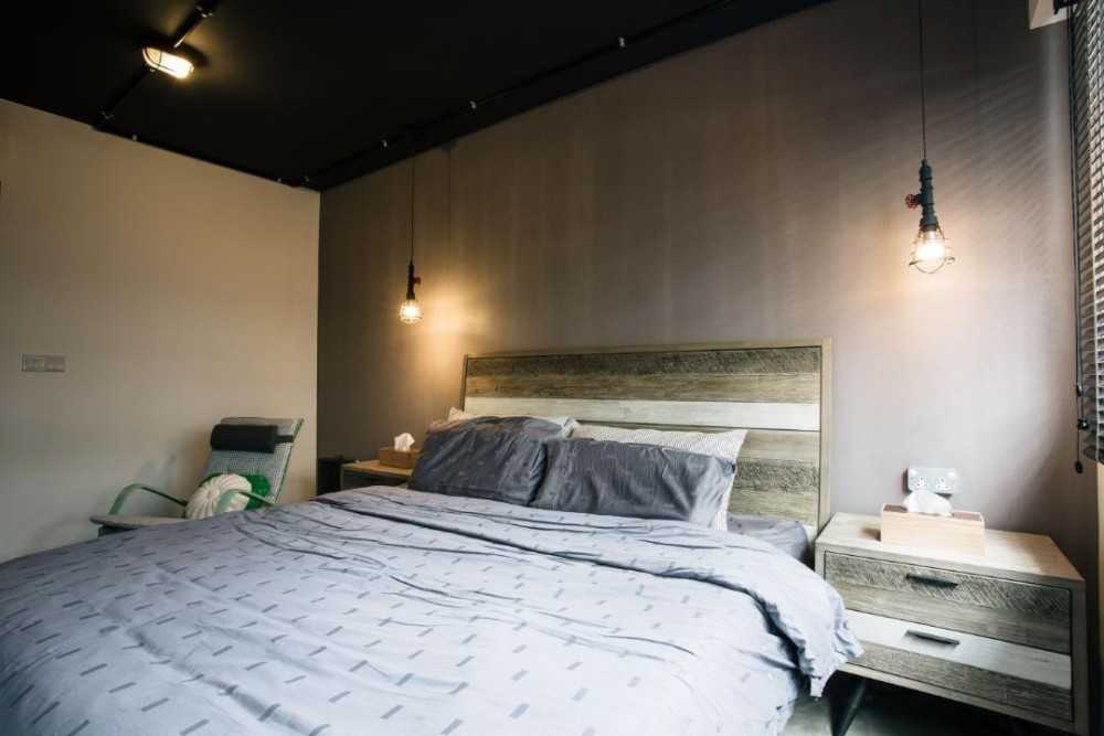 Industrial Bedroom with Drop Light and Bedside Table