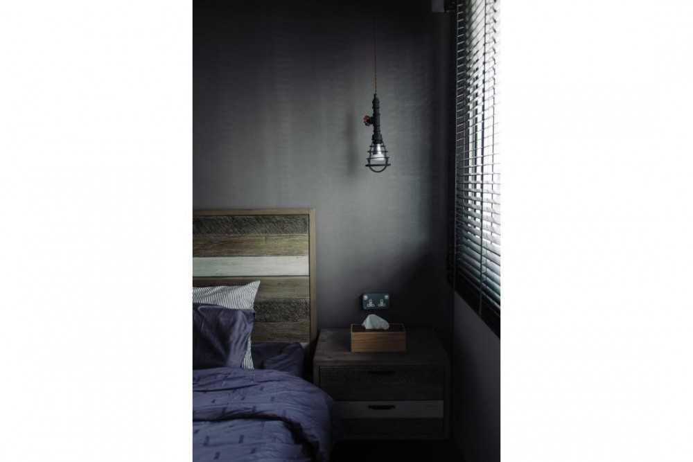 Industrial Bedroom with Drop Light and Bedside Table