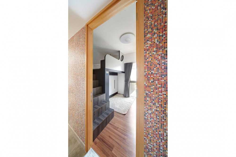 Eclectic Hallway with Staircase and Bed