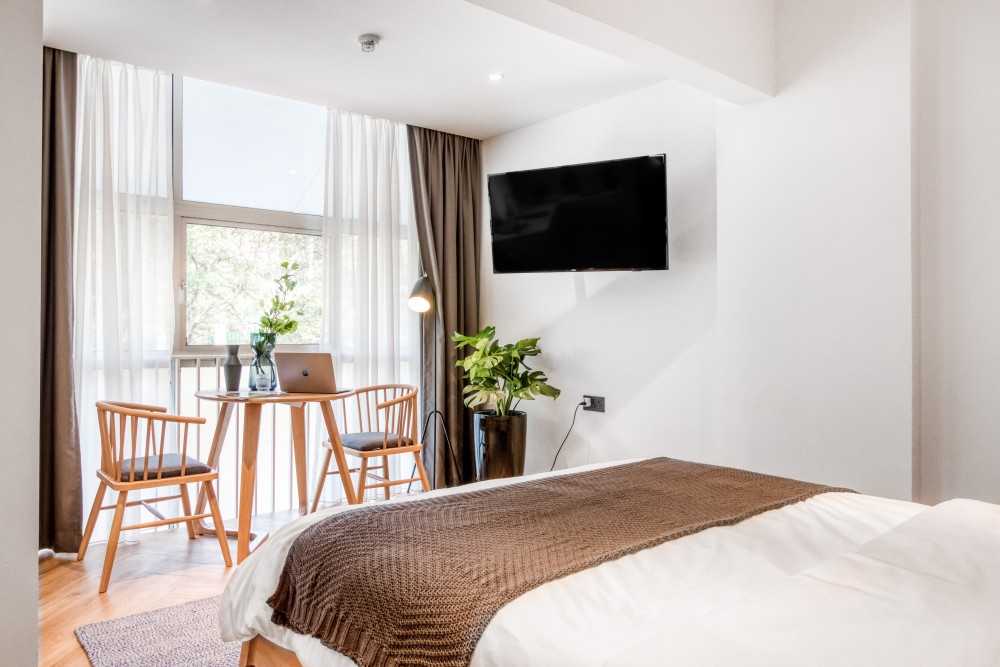 Transitional Bedroom with TV and Desk Chairs