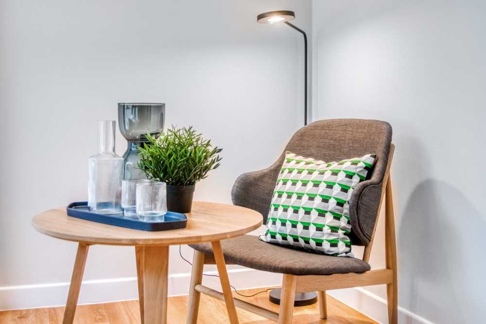 Transitional Bedroom with Armchairs and Coffee Table