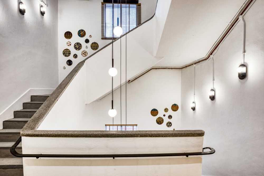 Transitional Hallway with Drop Light and Staircase