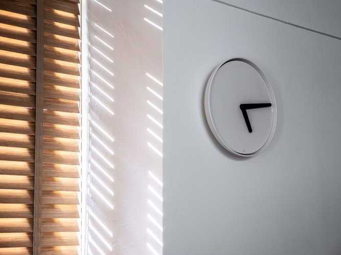Modern Hallway with Clock and Blinds