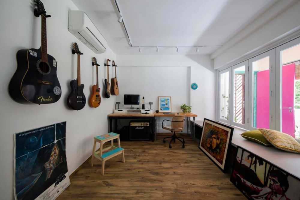 Eclectic Study with Wood Flooring and Paintings