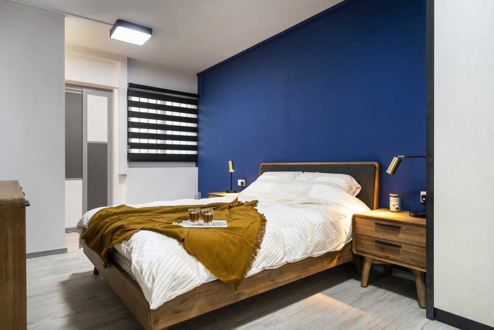Minimalist Bedroom with Vinyl Flooring and Ceiling Light