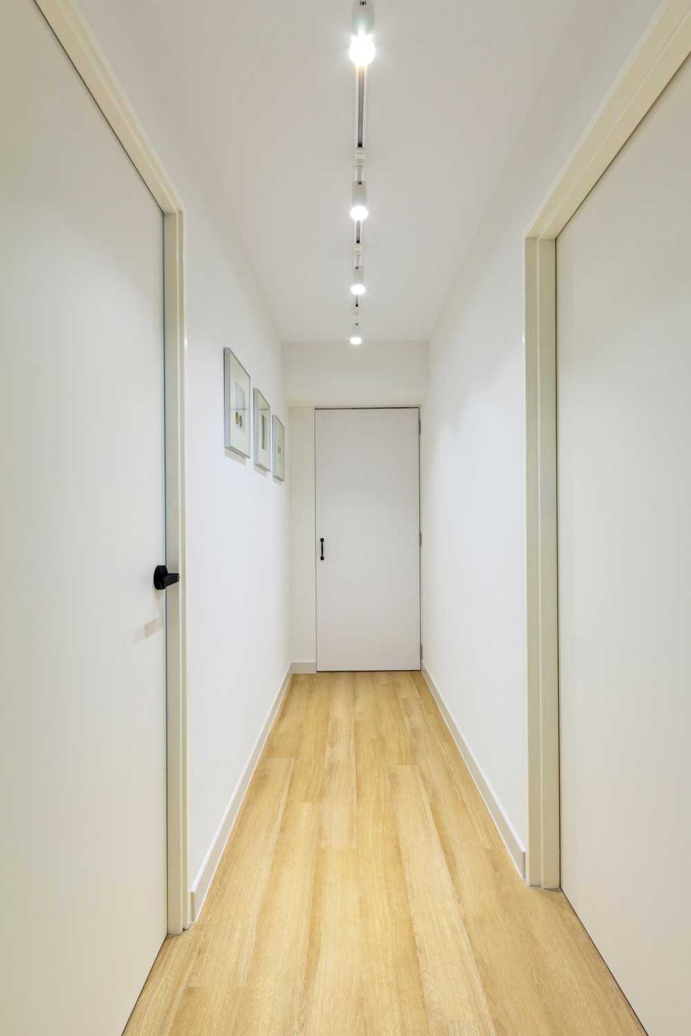 Minimalist Bedroom with Vinyl Flooring and Paintings