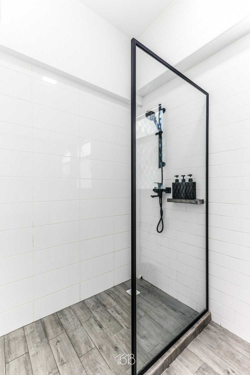 Minimalist Bathroom with Homogeneous Tiles and Glass Door