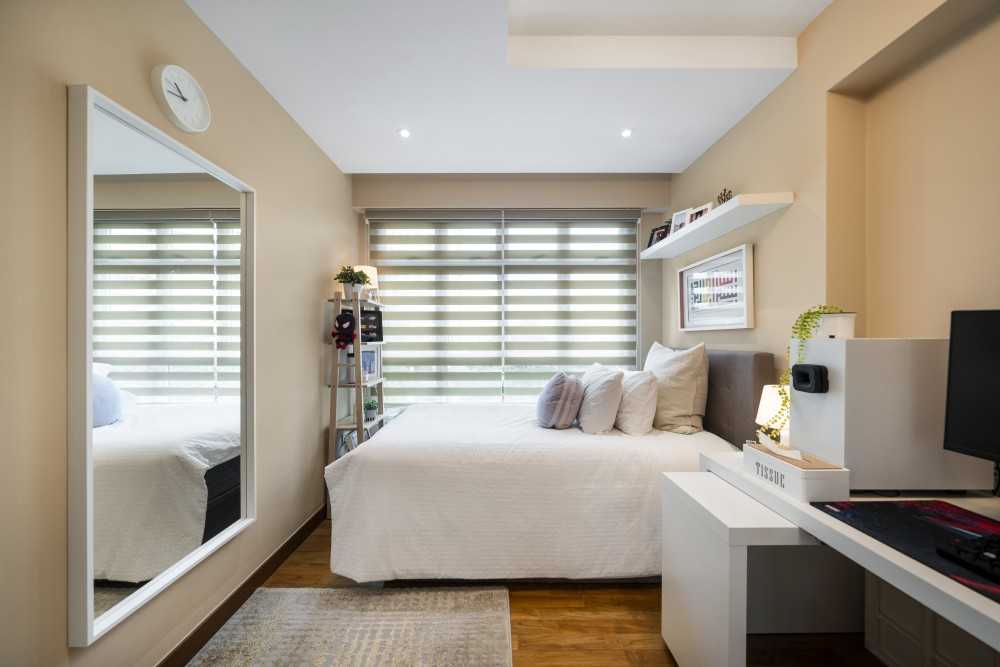 Modern Bedroom with Wood Flooring and Mirror