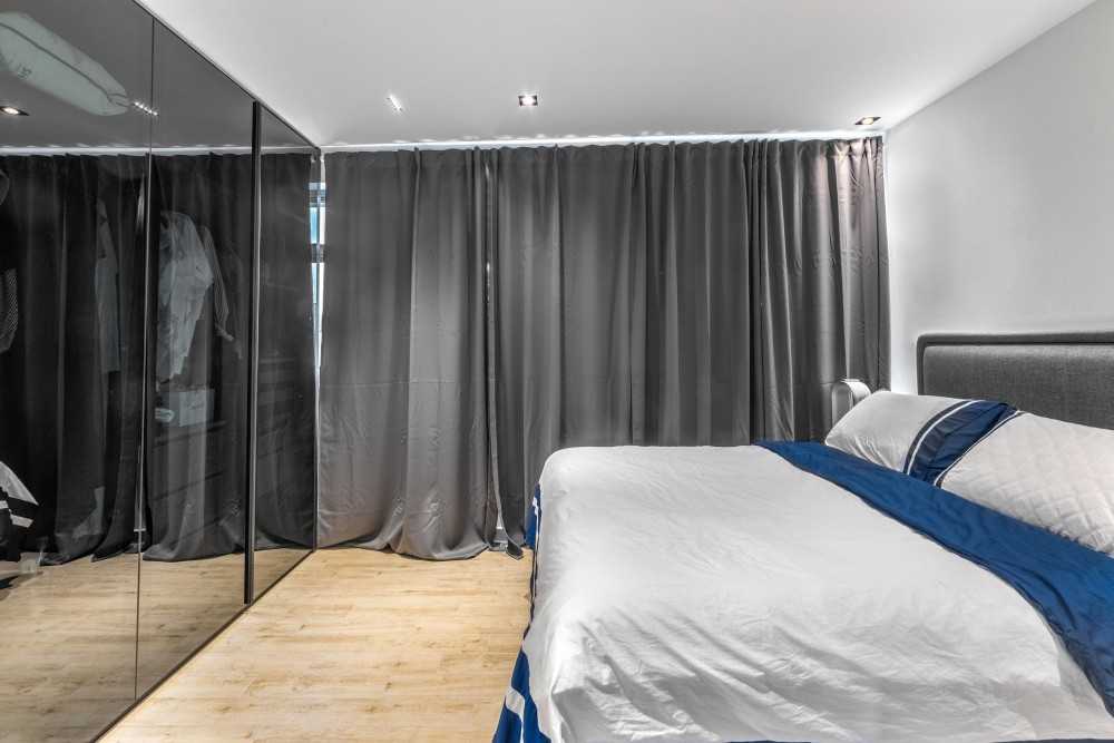 Modern Bedroom with Wood Flooring and Ceiling Light