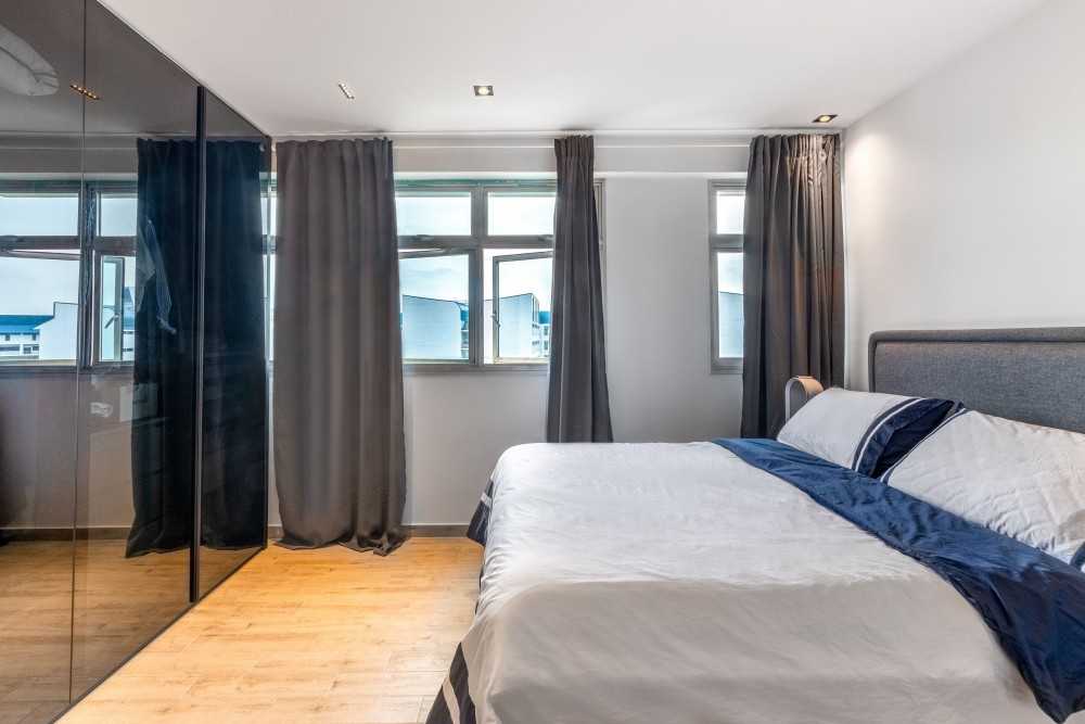 Modern Bedroom with Wood Flooring and Ceiling Light