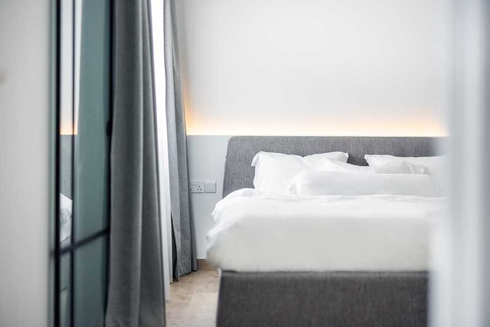 Minimalist Bedroom with Vinyl Flooring and Cove Lighting
