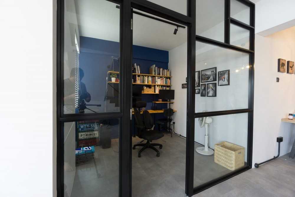 Industrial Home Office with Bookshelf and Desk Chairs
