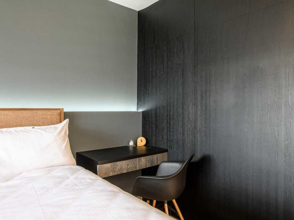 Industrial Bedroom with Wood Flooring and Cove Lighting