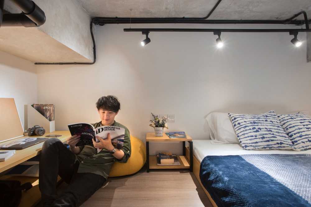 Industrial Bedroom with Bookshelf and Wood Flooring