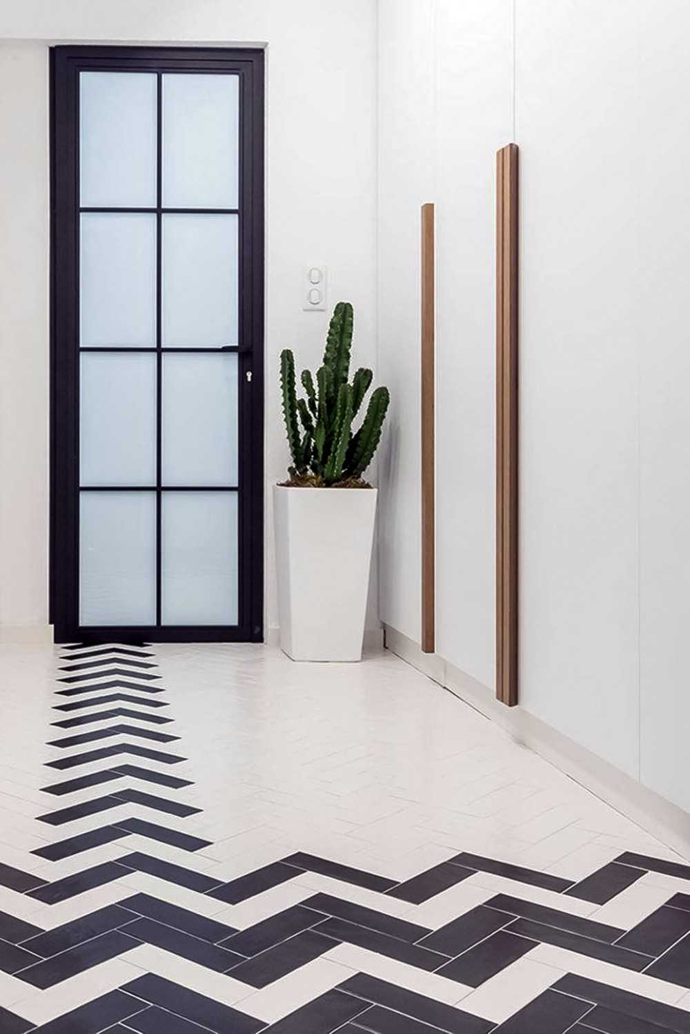 Transitional Hallway with Bookshelf and Artwork