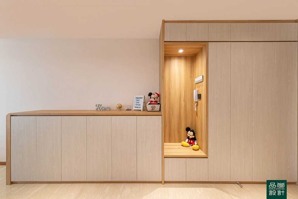 Scandinavian Foyer with Paintings and Storage Cabinets