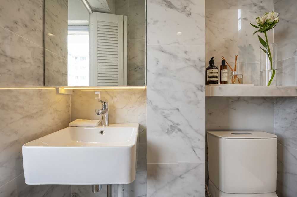 Eclectic Bathroom with Homogeneous Tiles and Mirror