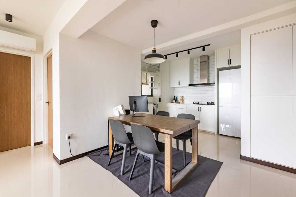 Minimalist Dining Room with Drop Light and Carpet