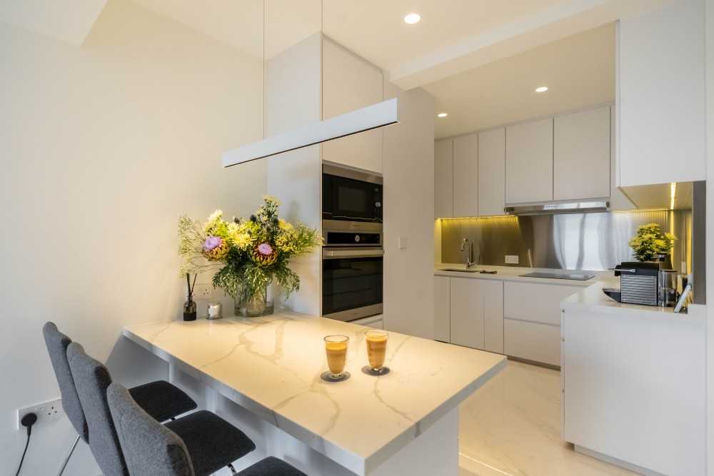 Minimalist Kitchen with Herringbone Tiling and Wood Flooring