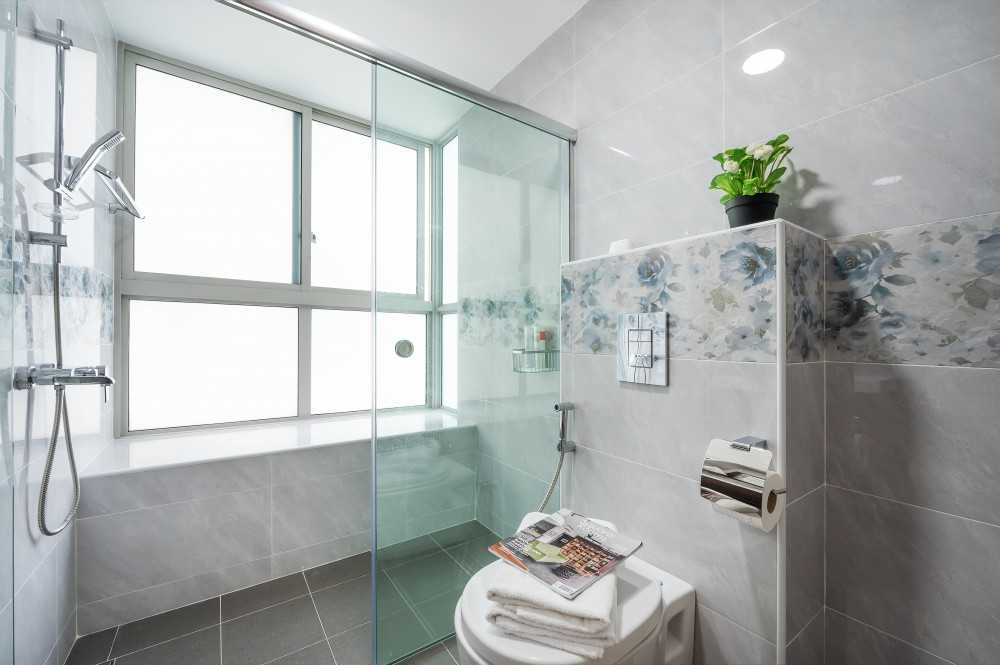 Asian Bathroom with Homogeneous Tiles and Shower Screen