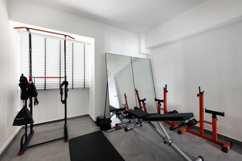 Minimalist Home Gym with Ceiling Light and Seating Bench