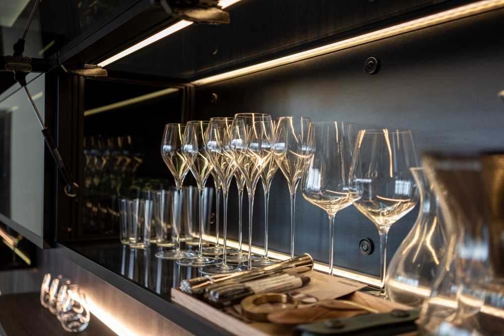 Contemporary Home Bar with Glass Door and Drinkware
