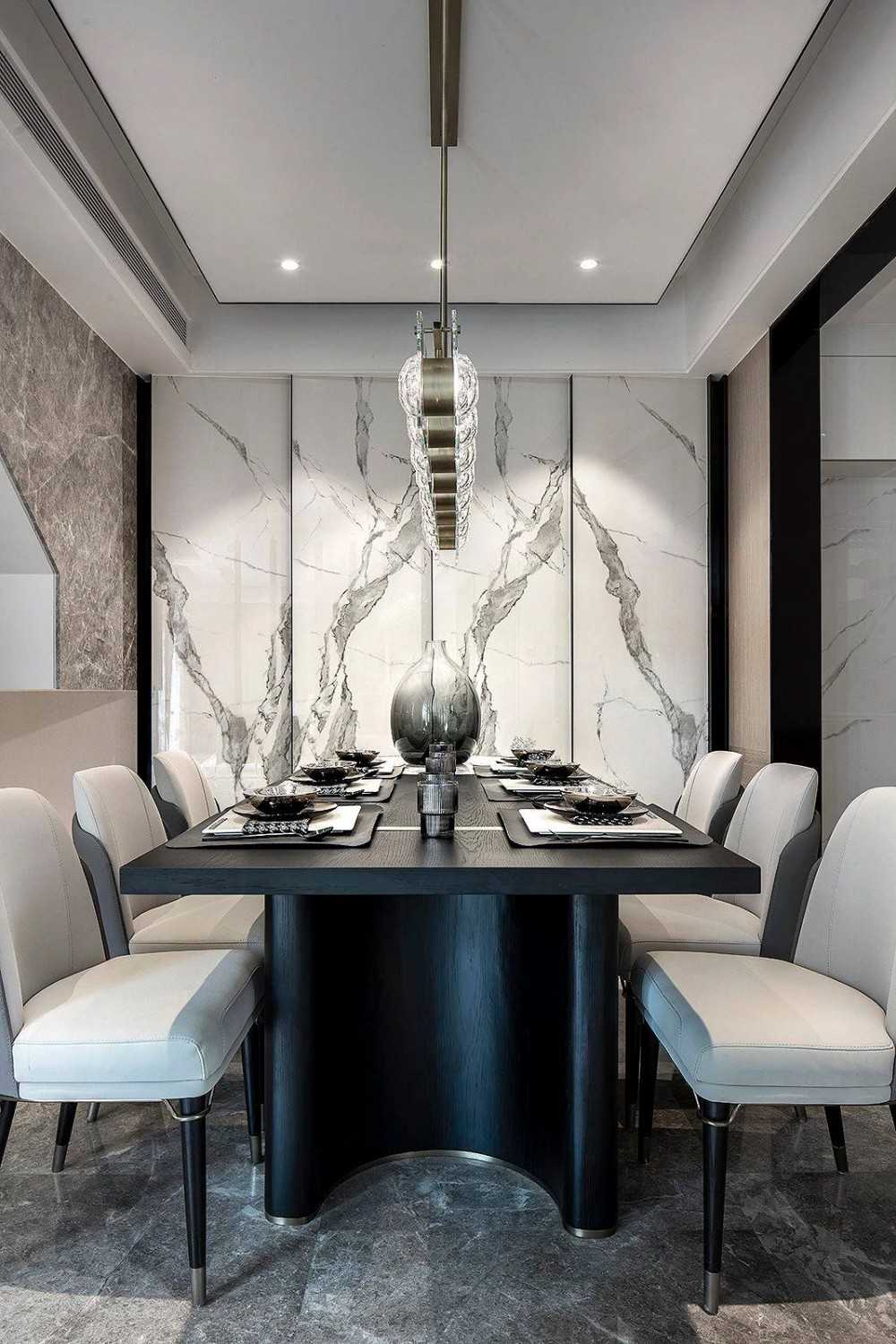 Contemporary Dining Room with Feature Wall and Drop Light